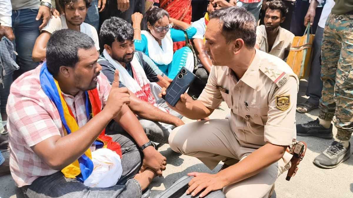 हसनगंज प्रखंड मुख्यालय की मुख्य सड़क पर प्रदर्शन करते आदिवासी समाज के लोग।